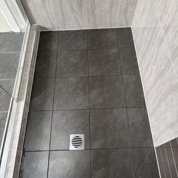 Bathroom tiled wall checked for shower leaking behind tiles